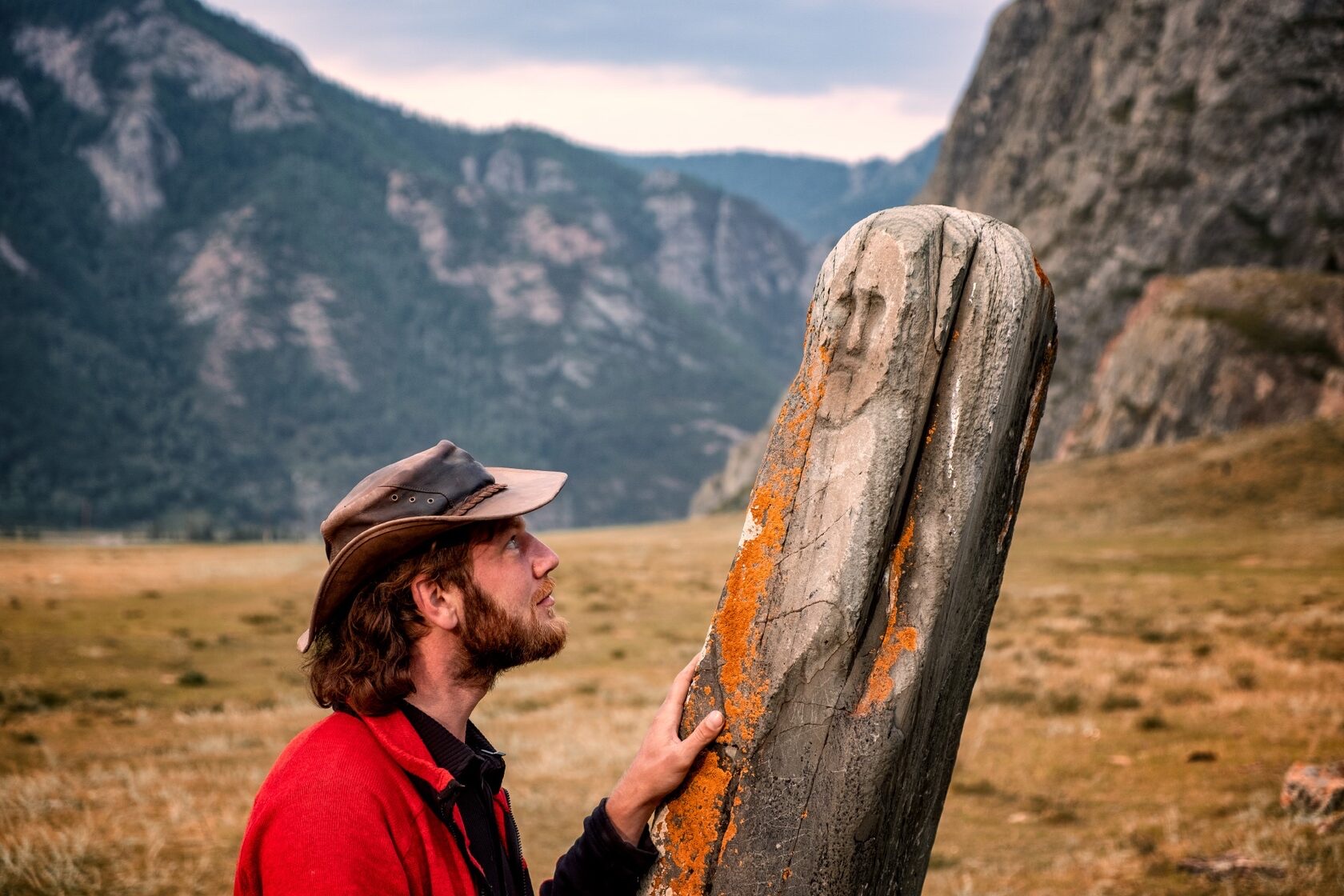 Alex Farlander beside a standing stone in the Altai Mountains